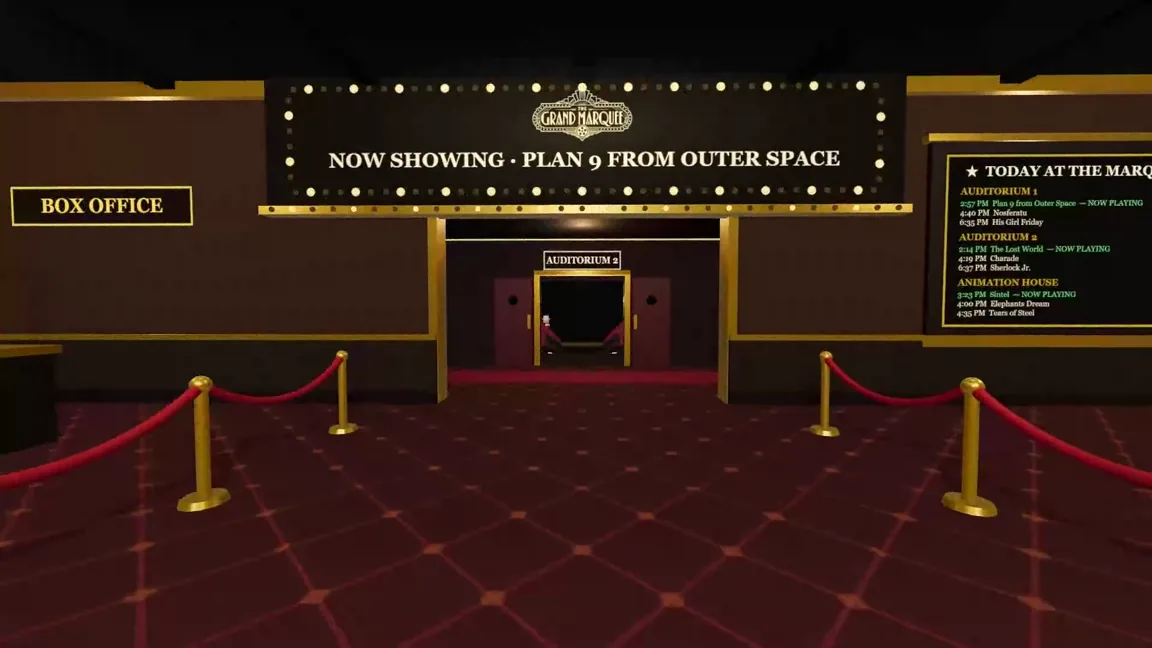 The Art Deco lobby with a lit NOW SHOWING marquee above the Auditorium 2 doors