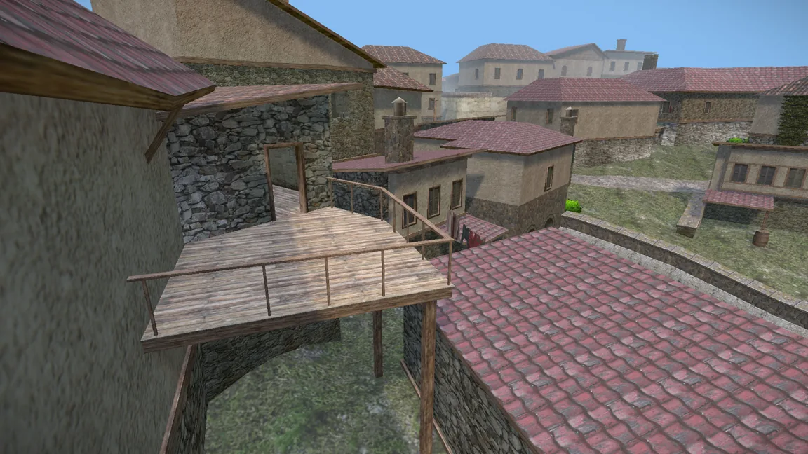 A wooden catwalk crossing above tiled rooftops in a hillside village